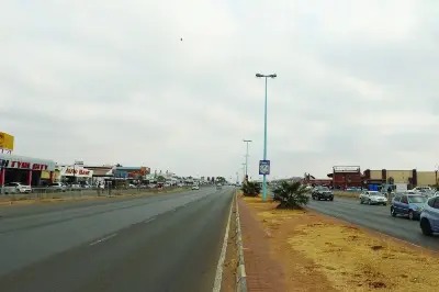 The main commercial road through Mogoditshane, lined with shopfronts